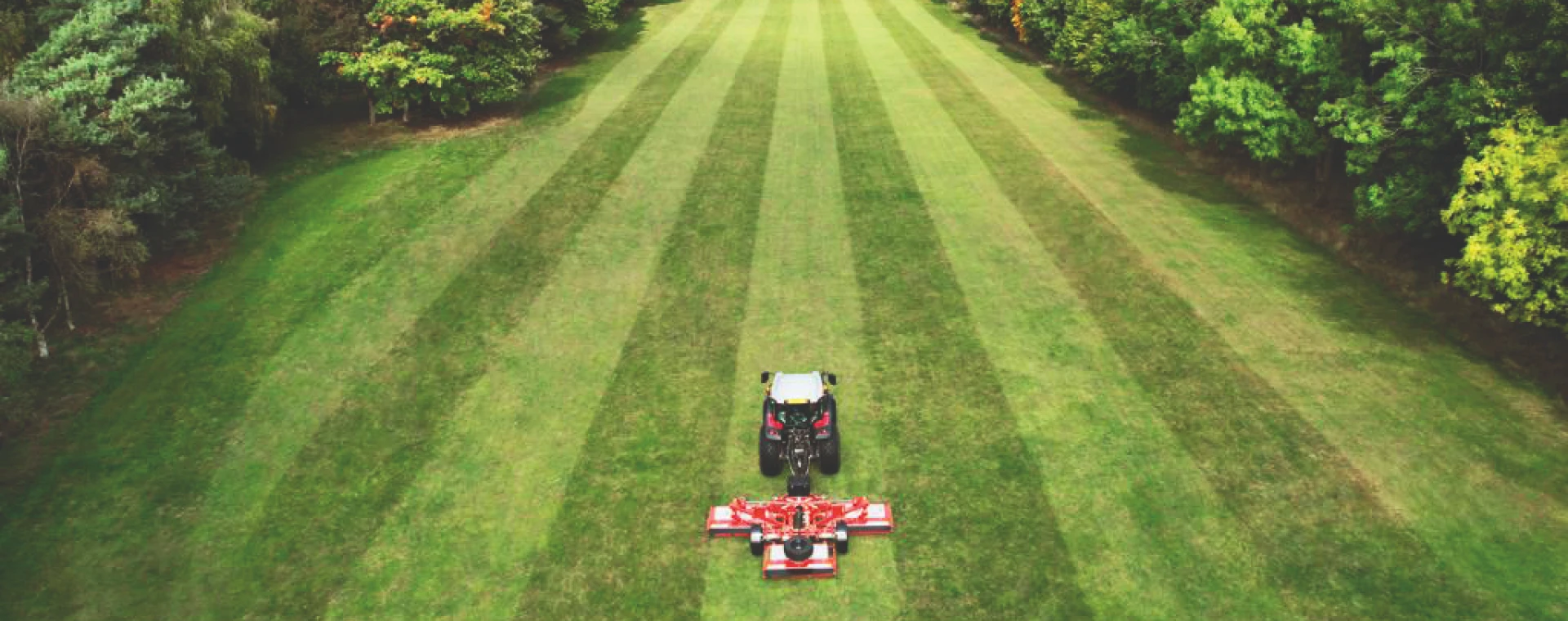 Tractor cutting grass aerial shot